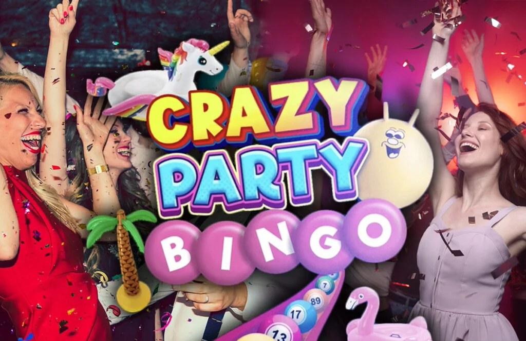 A crowd of people all cheer and raise their arms as confetti falls. Bingo balls and pool floaties of a palm tree, unicorn and flamingo, plus a bouncing ball surround the text 'Crazy party bingo' in the center.