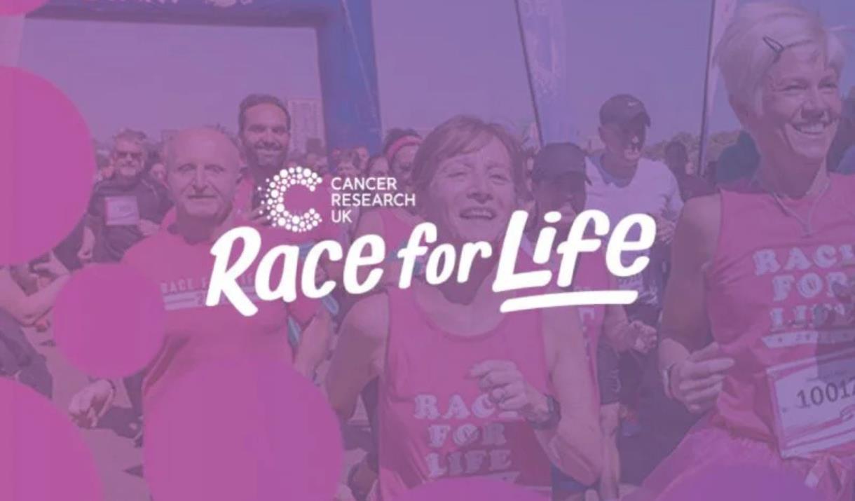 Race for Life - a crowd of runners in Pink shirts run forward. Over them is a purple saturation.