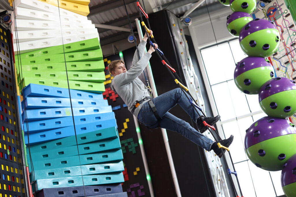 A climber on a rope ladder at the Rock Up indoor climbing centre in Weston-super-Mare