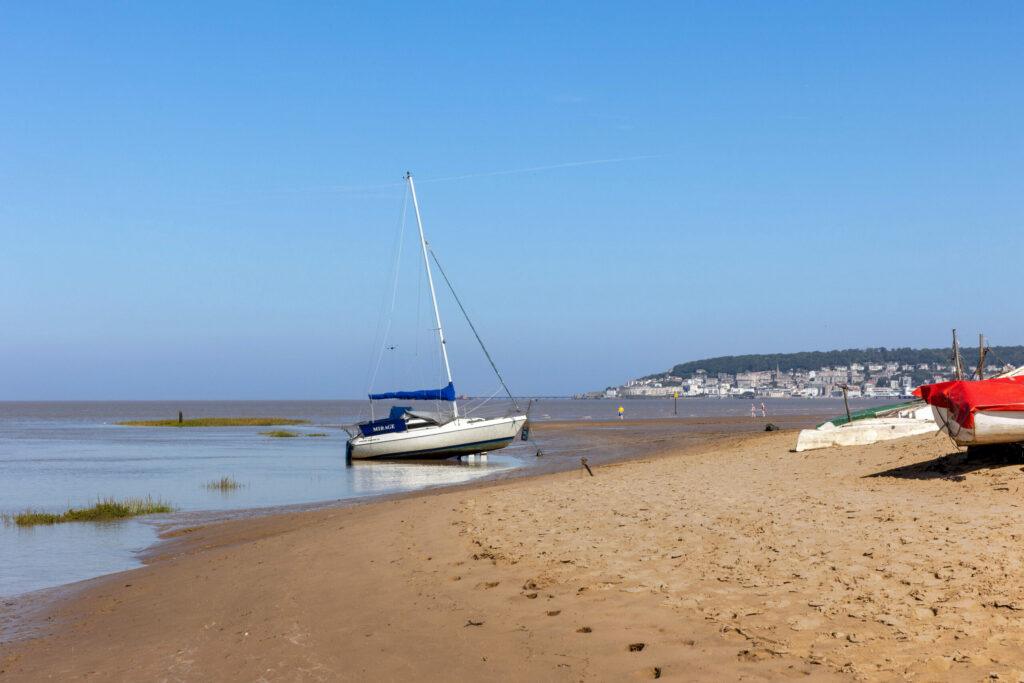 A sailing boat at the water's edge at Uphill Beach, Weston-super-Mare
