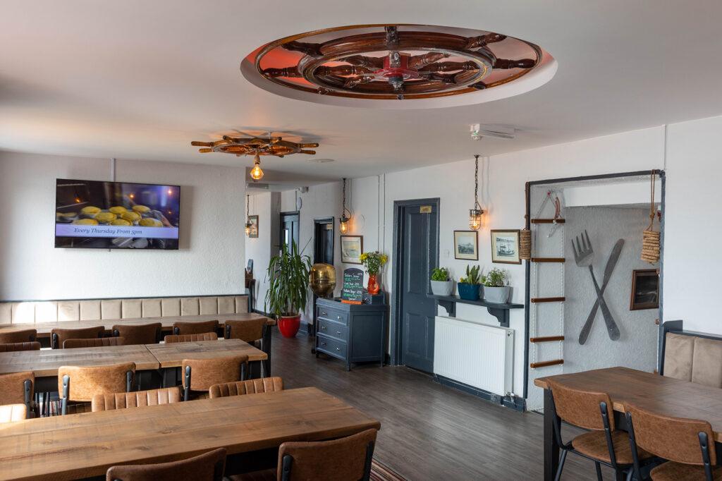 Restaurant in the Captains Cabin, Weston-super-Mare featuring ships steering wheels on the ceiling