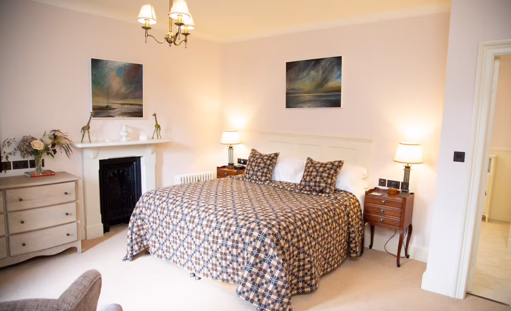 A modern double bedroom at Uphill Manor