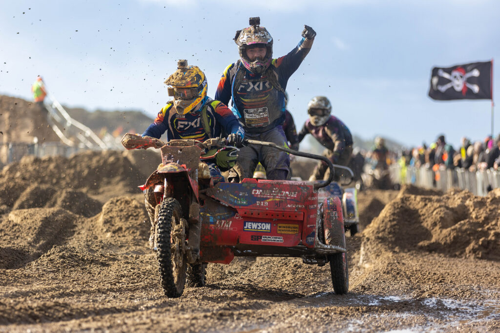 A sidecar rider in the Weston Beach Race gives the thumbs up