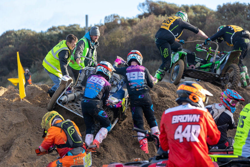Stewards help riders stuck in the sand at the Weston Beach Race