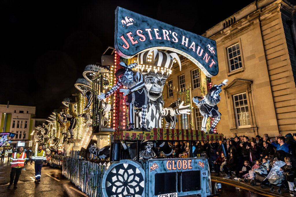People dressed as jesters on board a float at the Weston Carnival