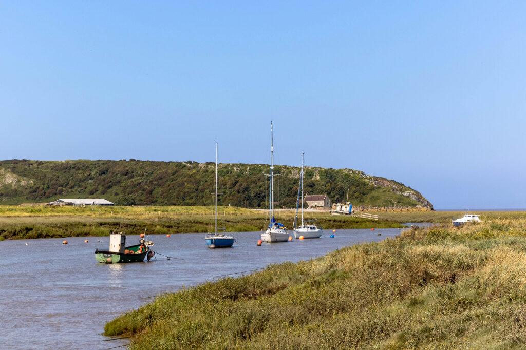 Boats on the river out to sea at Uphill
