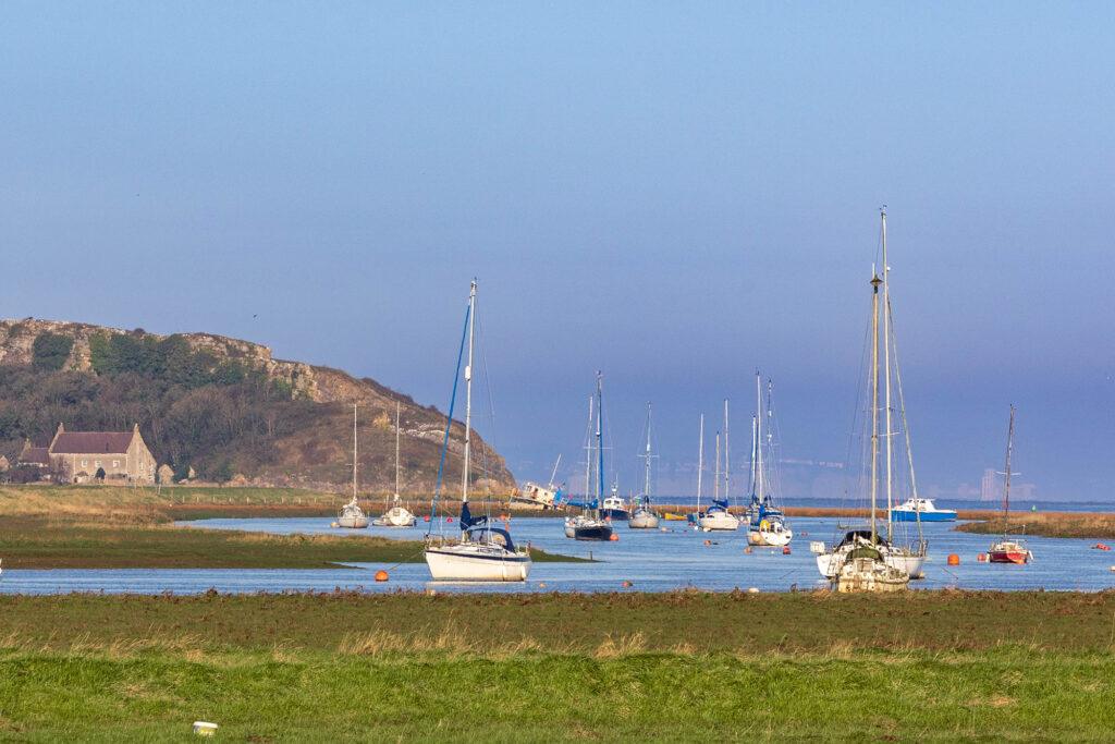Lots of boats on the river leading out to sea at Uphill, Weston-super-Mare