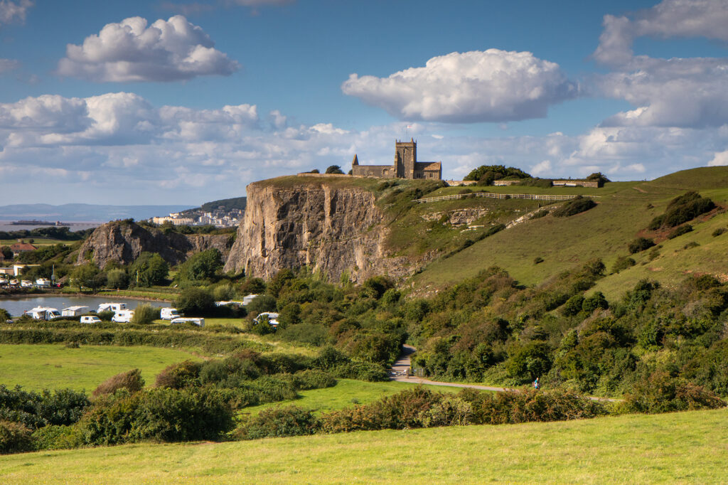 View across fields to the cliffs and St Nicholas Church, Uphill