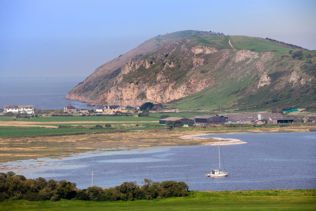 The huge rock and headland of Brean Down as seen from across the water at Uphill