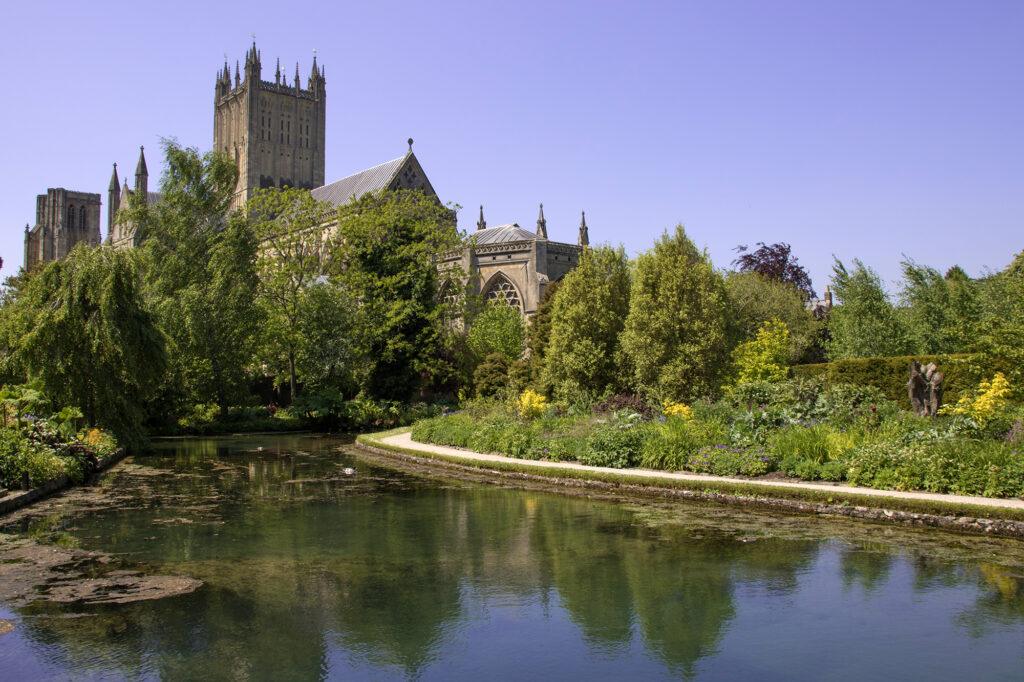 View of Wells Cathedral with the Bishop's Palace gardens in the foreground