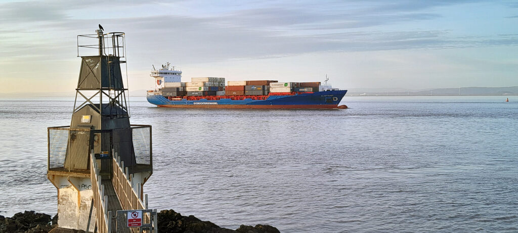 A huge container ship passing the lighthouse at Battery Point, Portishead