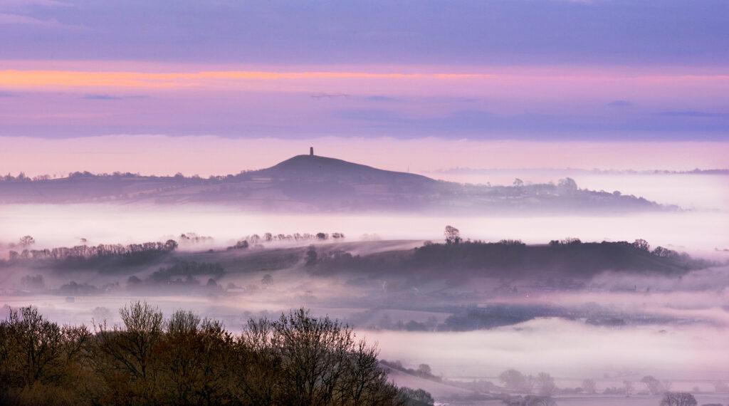 Glastonbury Tor in the distance rising out of the mist