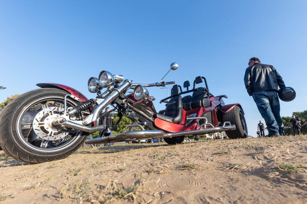 Low view of a sleek motorbike trike and an admirer at the Weston-super-Mare Bike Night