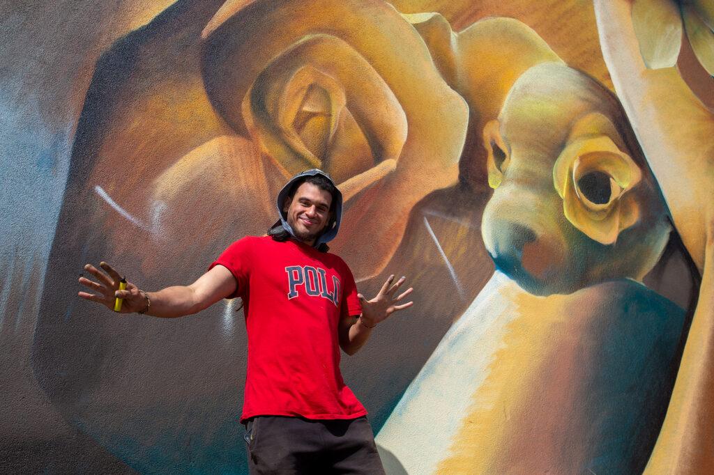 Street artist Curtis Hylton poses in front of his giant sea life mural in Weston-super-Mare, Somerset
