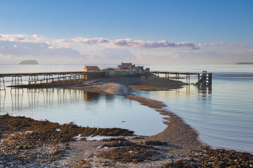 The narrow shingle causeway leading to Birnbeck Pier in Weston-super-Mare is partially covered by the sea