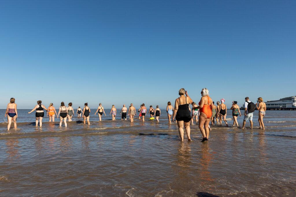 A large group paddle into the sea for a mass swim in Weston-super-Mare