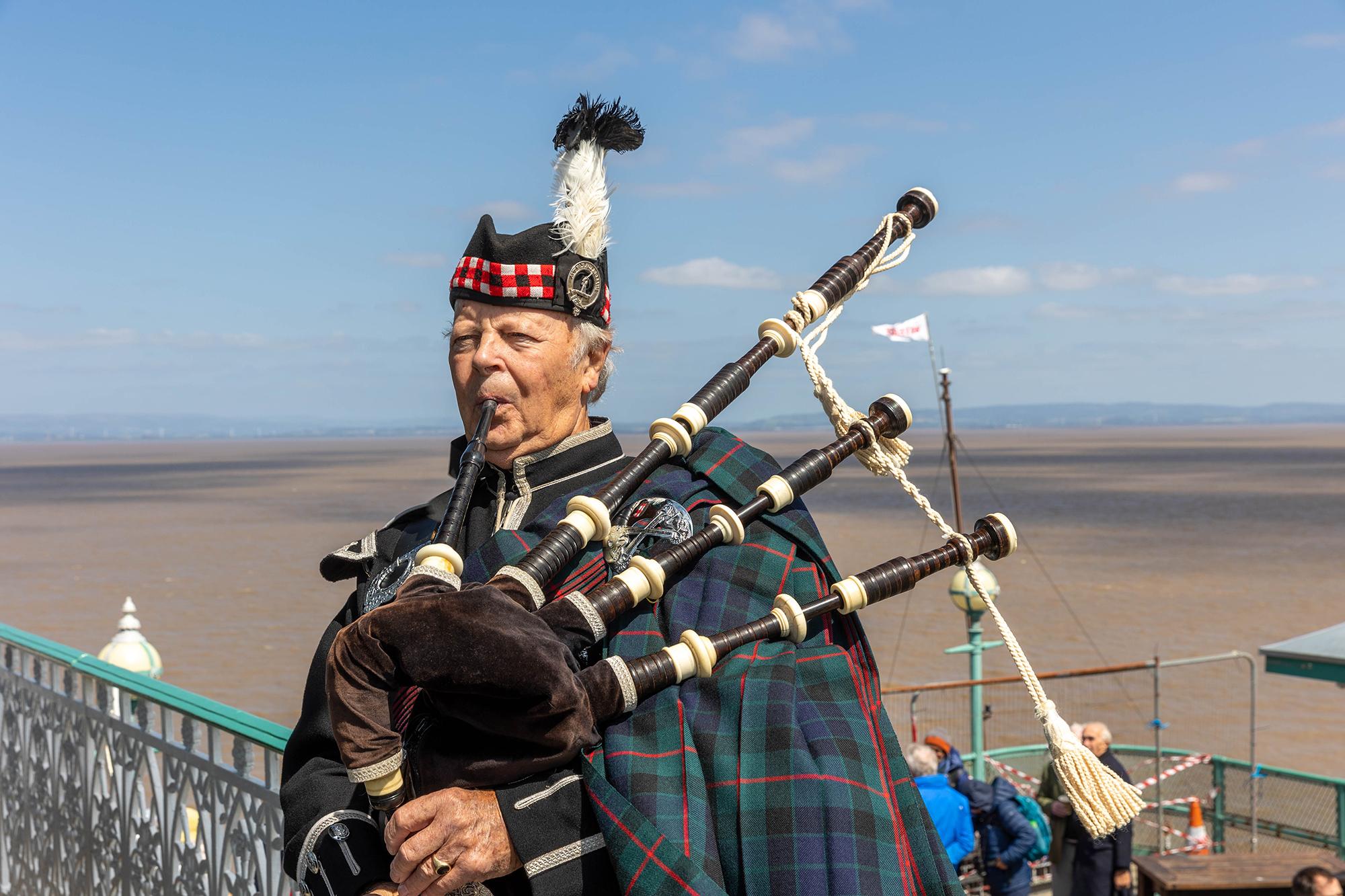 A bag piper in Scottish dress welcoming the Waverley paddle steamer to Clevedon