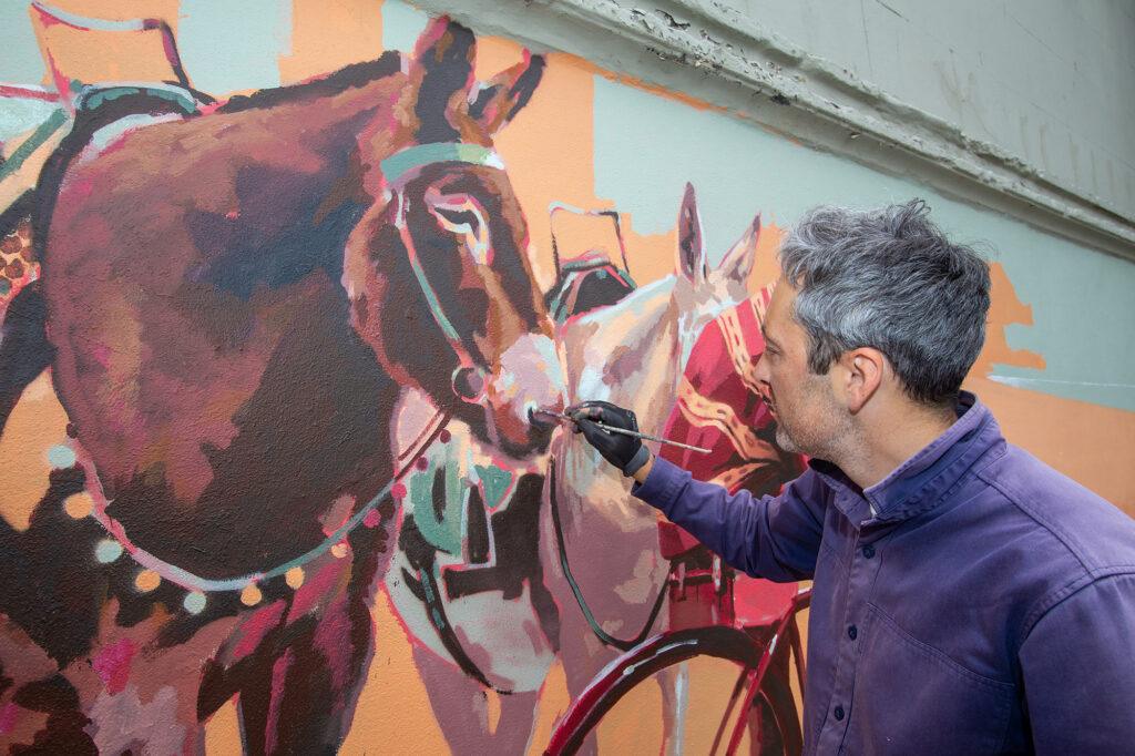 A street artist brings one of Weston-super-Mare’s iconic donkeys to life on a town centre wall