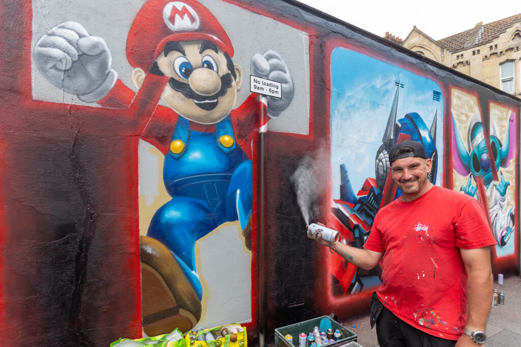 A street artist with the Super Mario character he's just created in Weston-super Mare