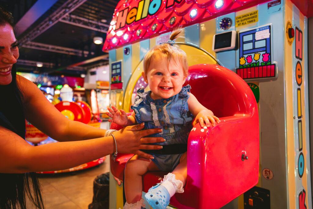 A toddler on a ride at the Grand Pier, Weston-super-Mare