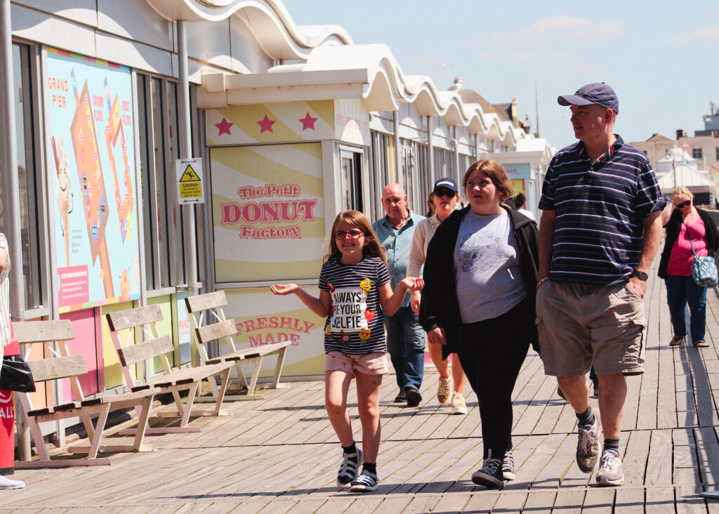 A family group walking down the Grand Pier, Weston-super-Mare