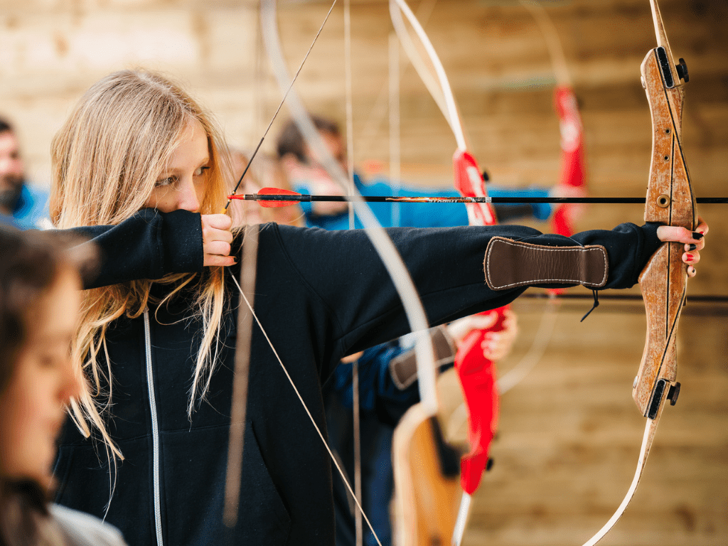 A girl takes aim during an archery class at the Mendip Activity Centre