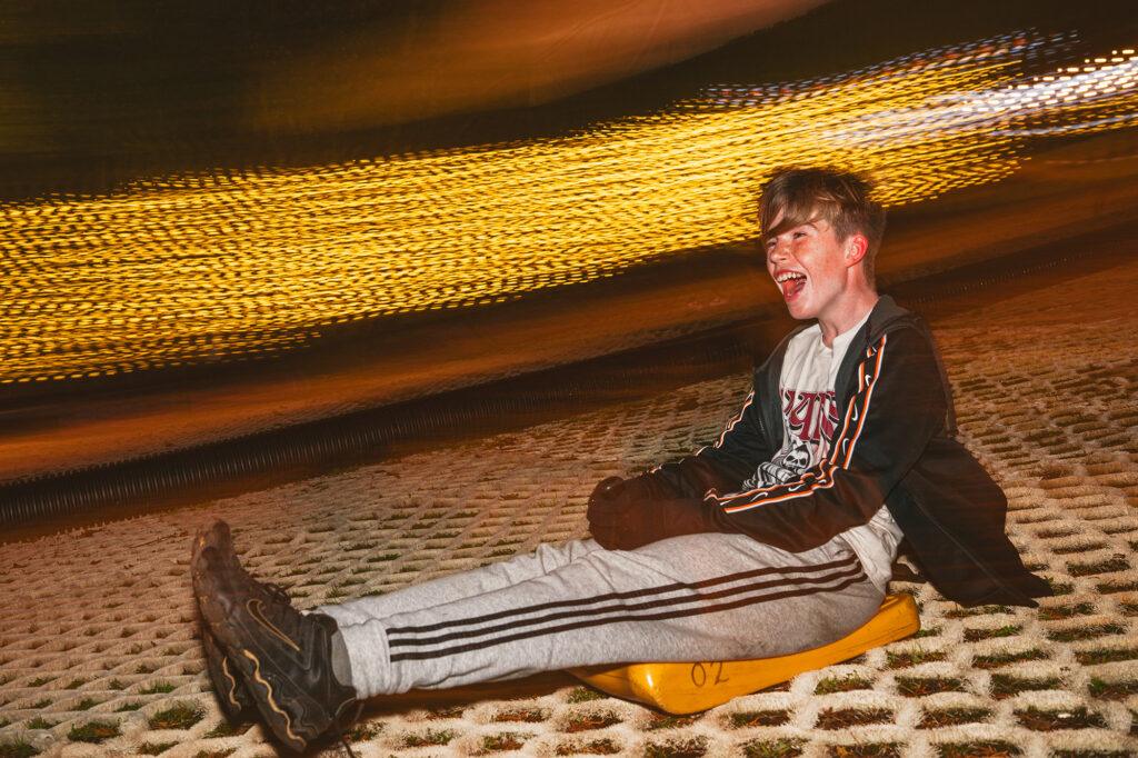 A teenager goes down the slope during the Mendip Activity Centre's twilight toboggan run