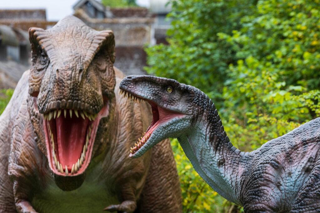 Two dinosaurs at Dinosaur Valley, Wookey Hole, baring their teeth