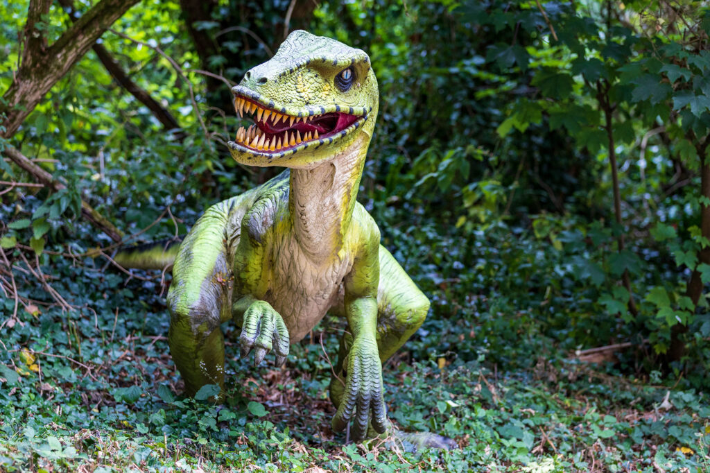 A dinosaur in undergrowth at Dinosaur Valley at Wookey Hole