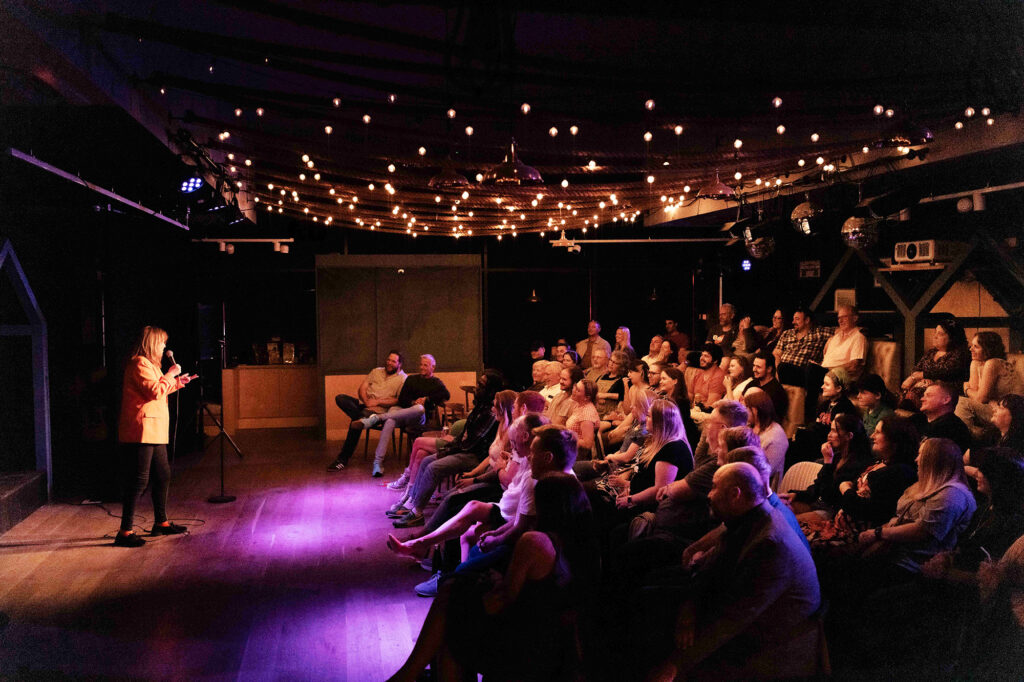 A comedian performing to the crowd at the Front Room fringe theatre, Weston-super-Mare