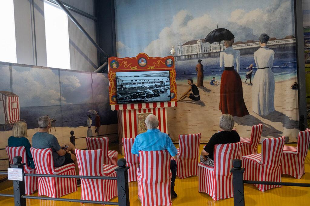 People sitting down watching an aviation film in the Helicopter Museum, Weston-super-Mare