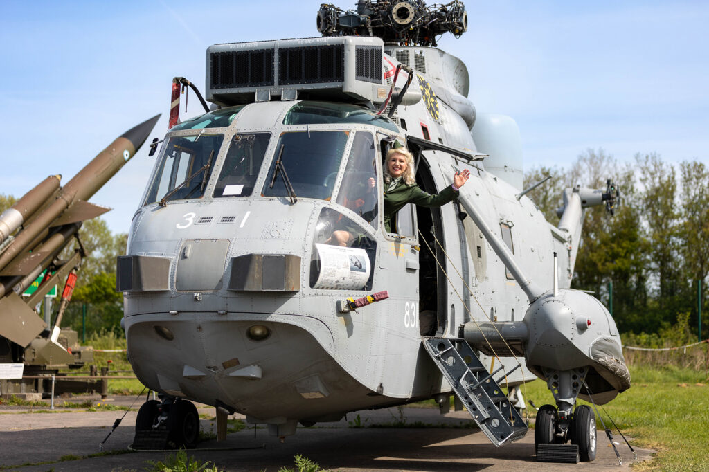 An army officer giving a wave outside the pilots window at the Weston Helicopter Museum