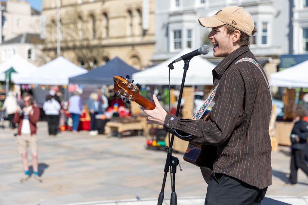 A singer performing at the Weston Weekly Market
