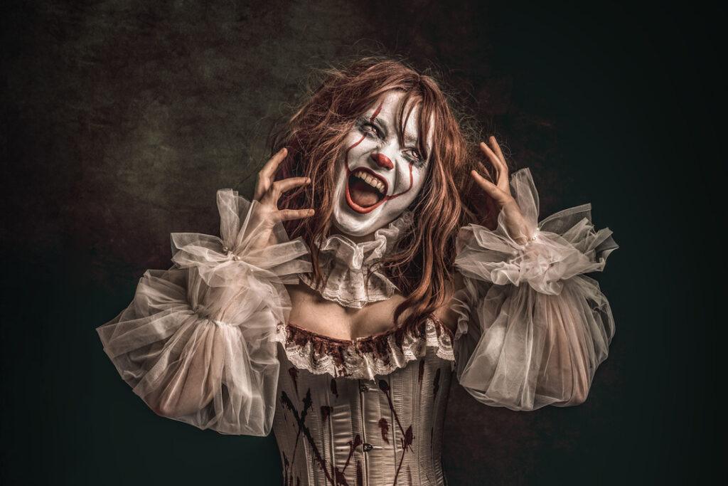A female Cosplay character with a white face with red blood streaks
