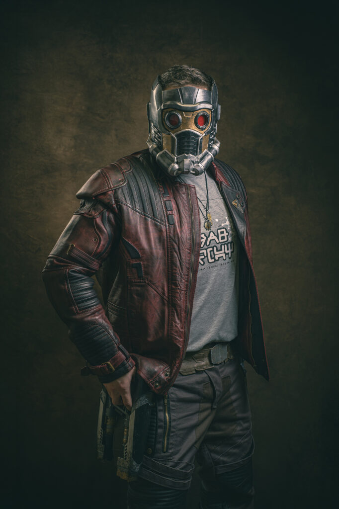 A cosplay character with a metal mask over his face