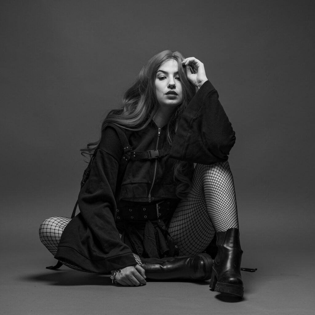 Black and white portrait of a won sitting on the floor