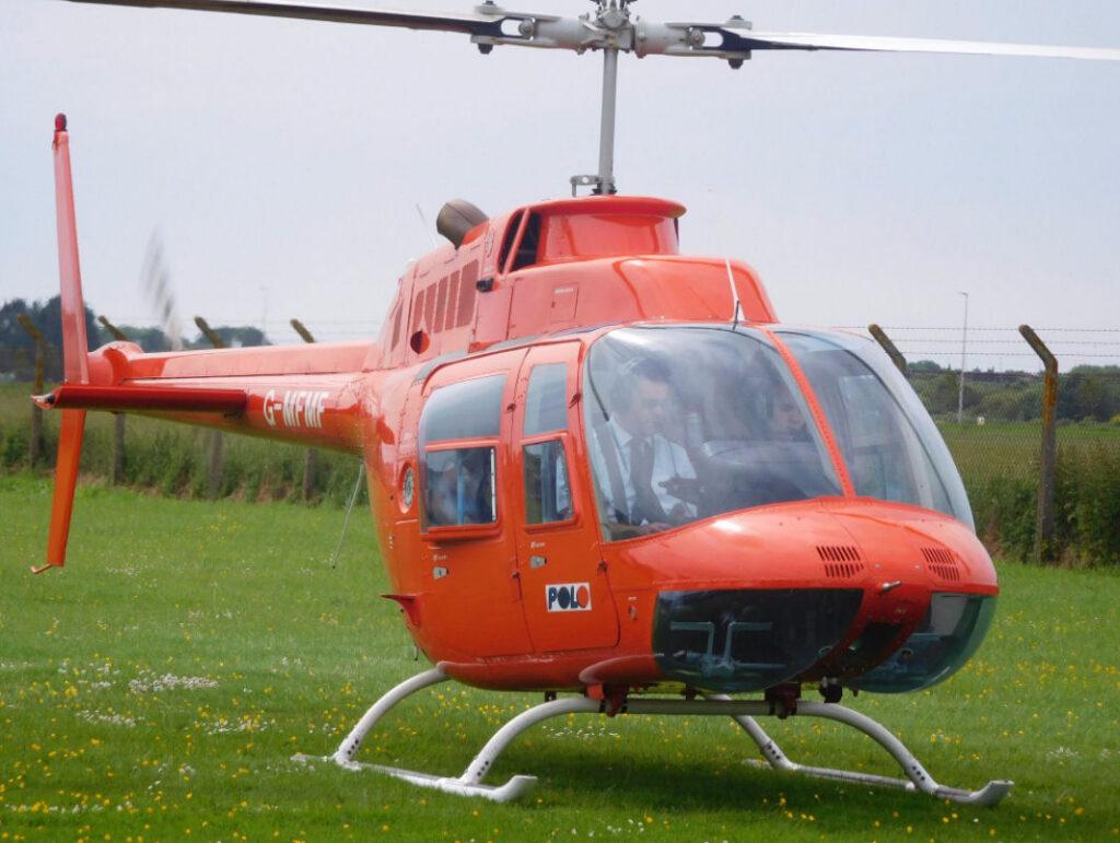 A red helicopter in a field
