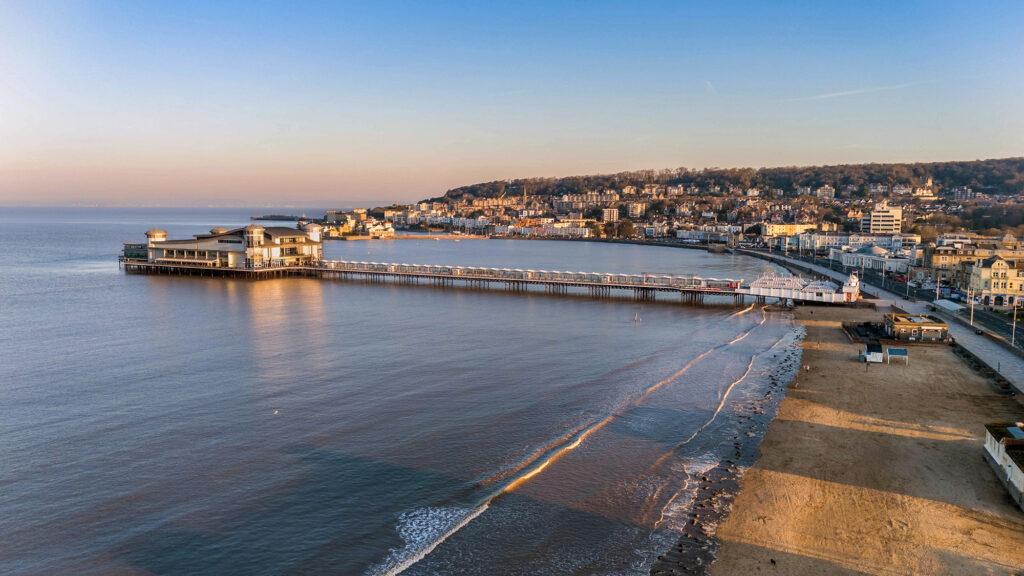 Weston Beach and Pier with the town, woods and Knightstone Island in the background