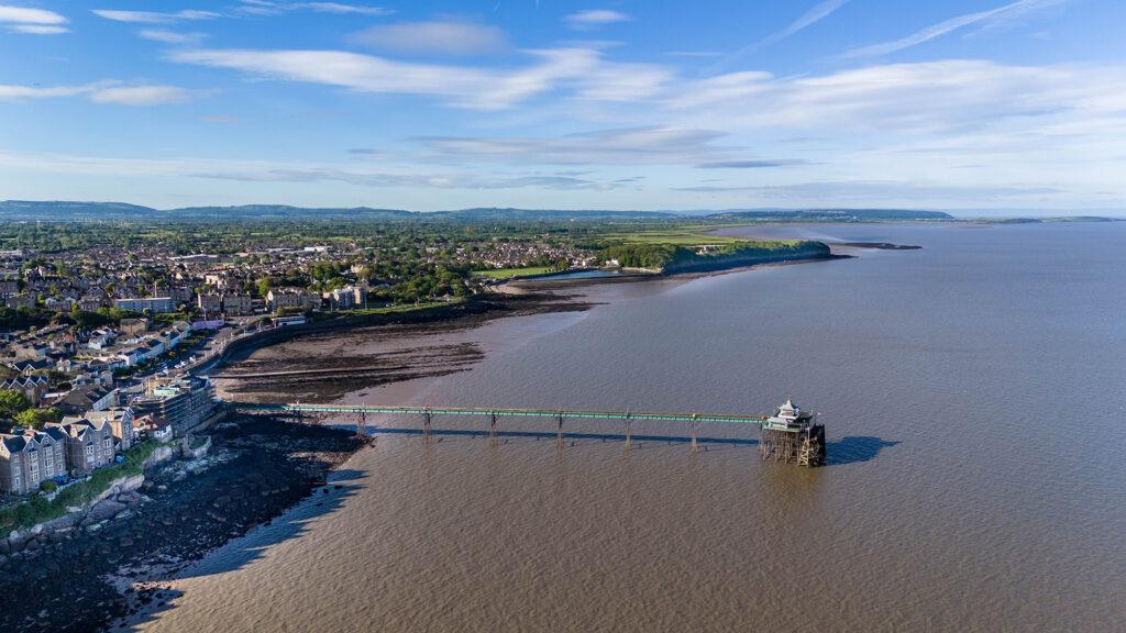 Aerial view looking down over the sea at Clevedon Pier, Clevedon and the North Somerset countryside