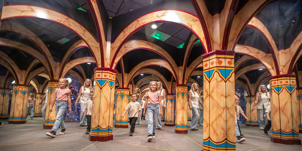 A family see multiple reflections of themselves in the mirror maze at Wookey Hole