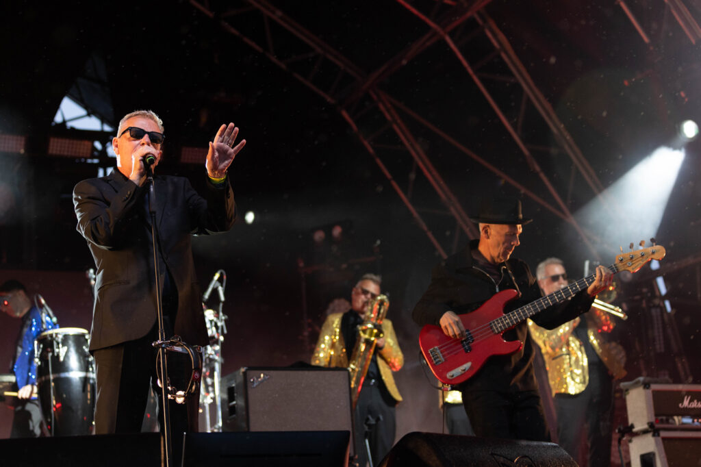 Four members of a male band on stage