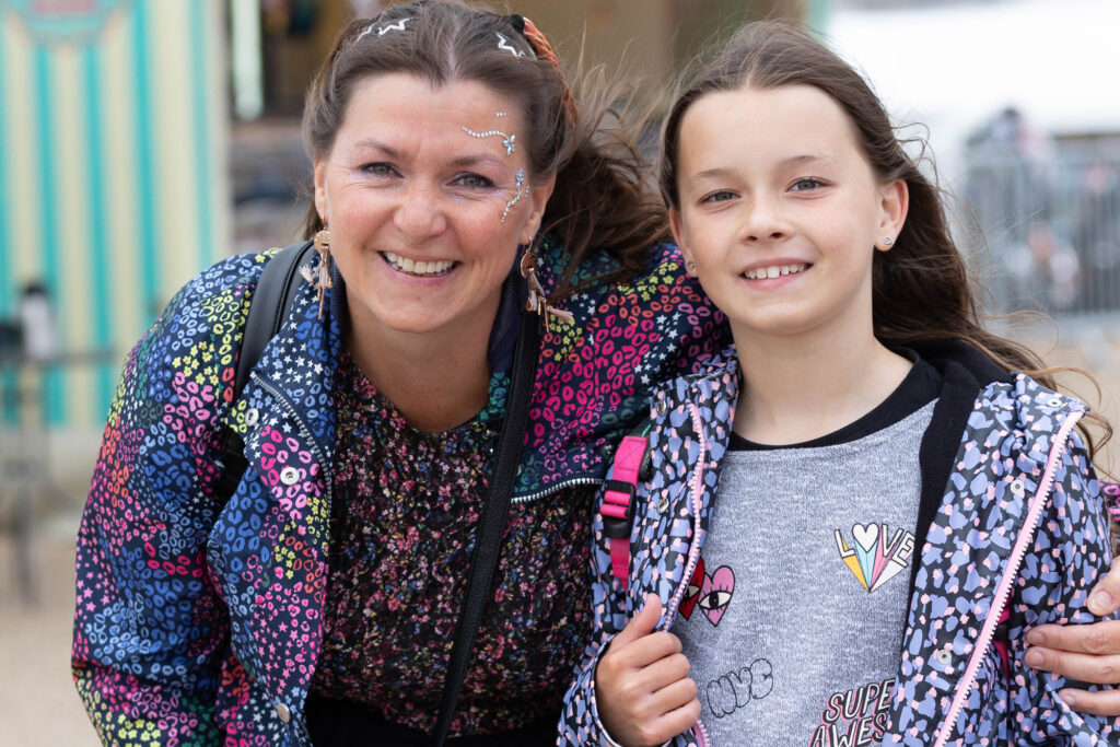 A mum with glitter on her face and her daughter