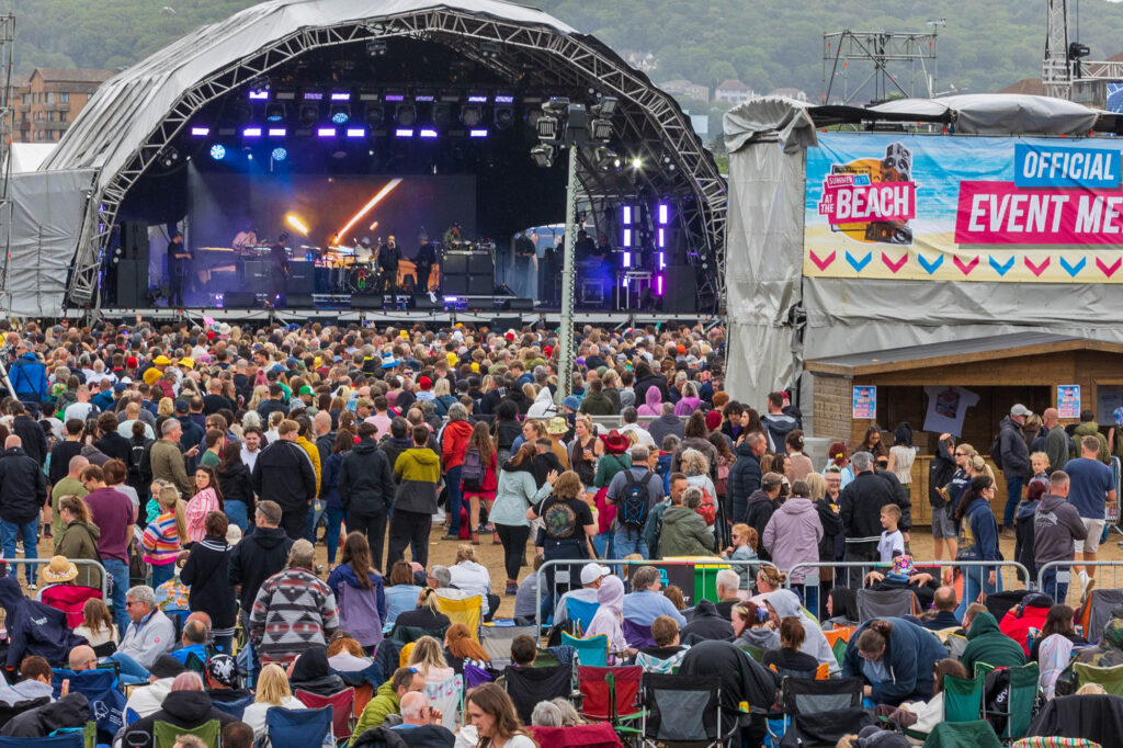 General view of a large music festival on a beach