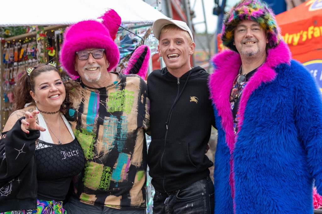 Three men and a lady pose for the camera