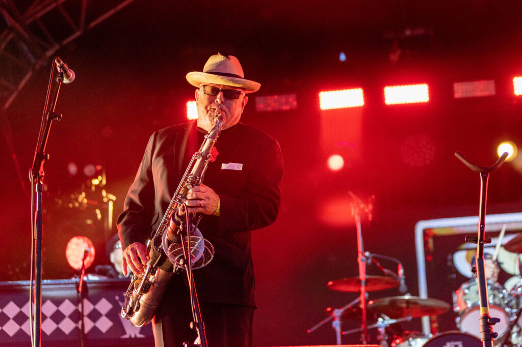 A man in a hat playing the saxophone