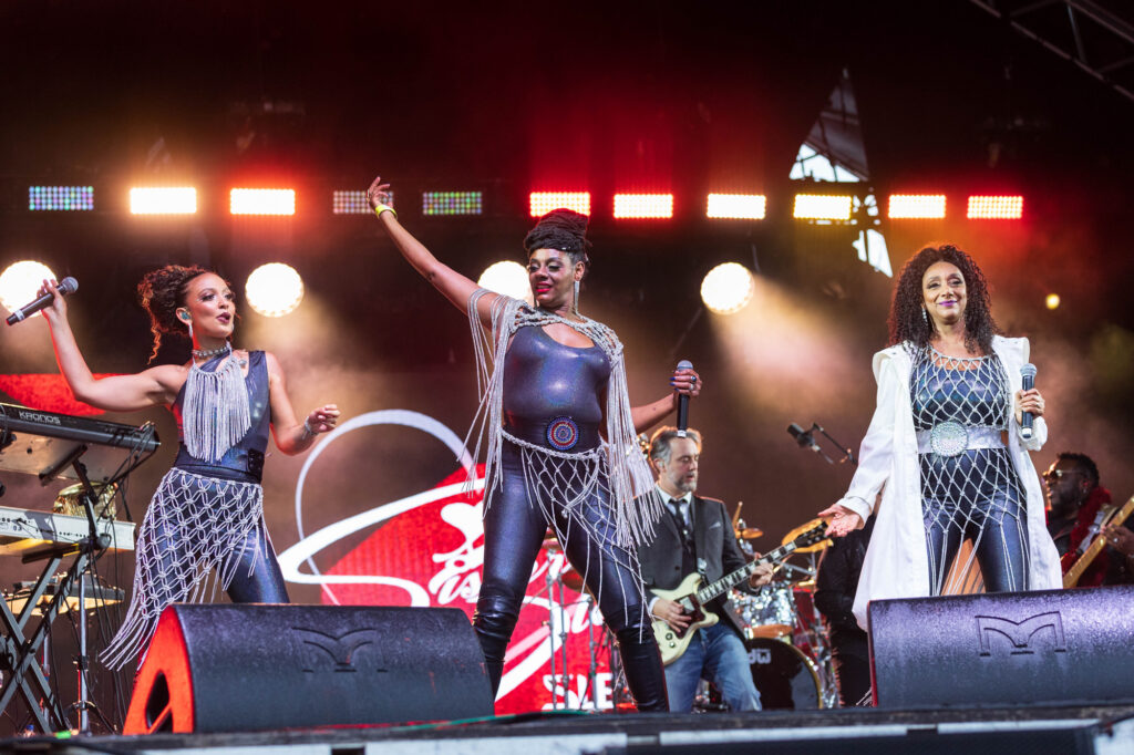 Three members of the girl band Sister Sledge performing on stage