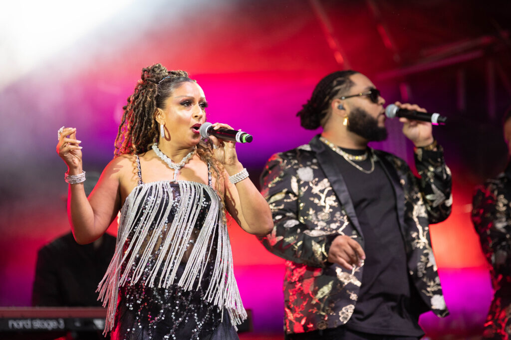 A man and a woman singing on stage