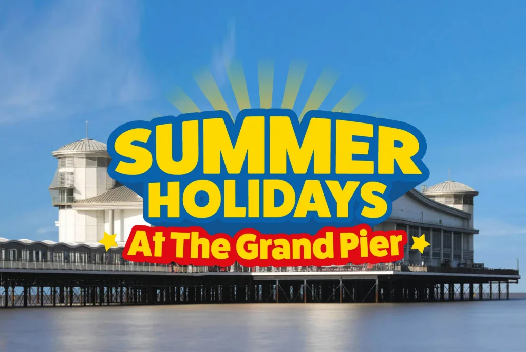 The Grand Pier with a blue sky. The text 'Summer holidays at the Grand Pier' sits over the top of the image