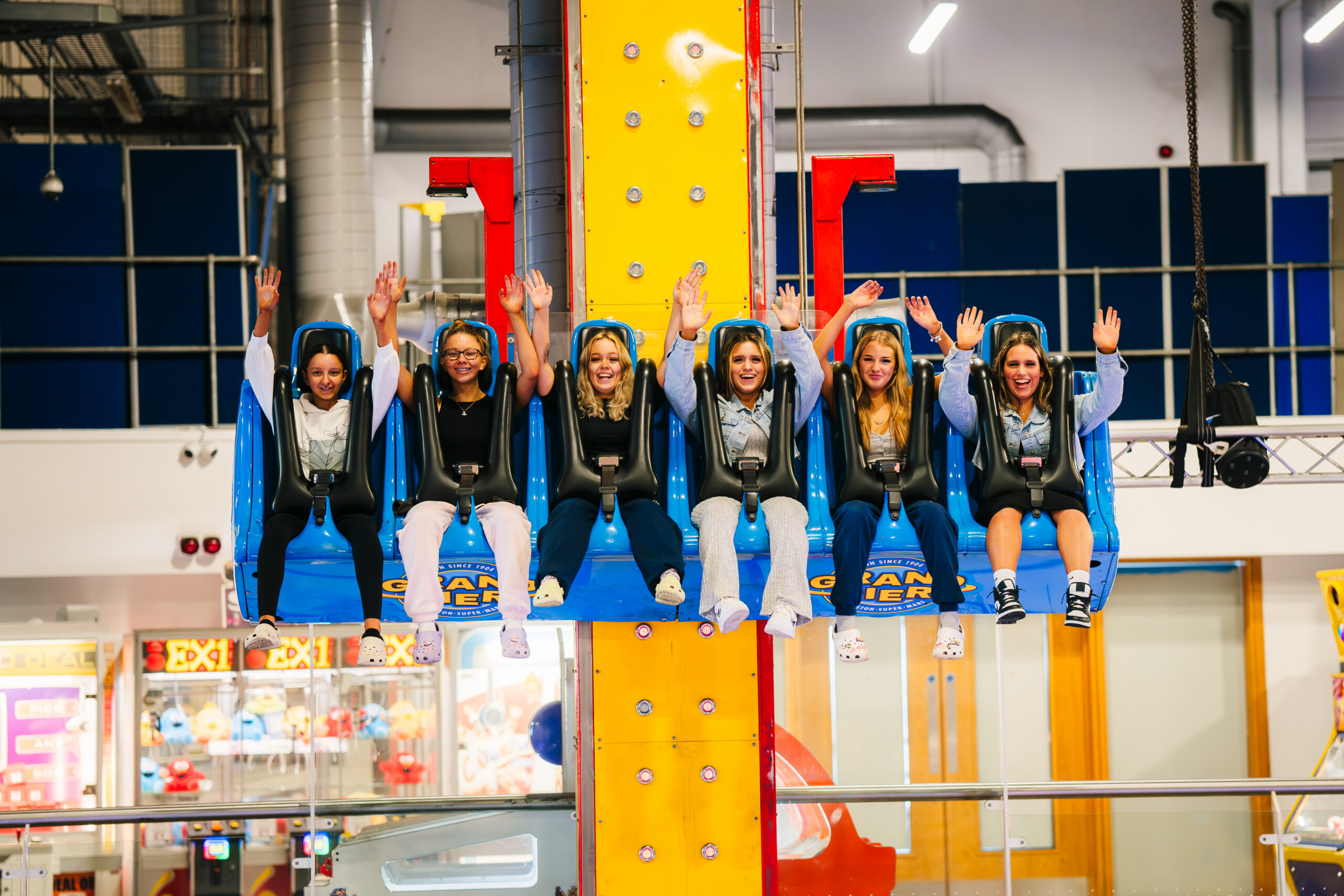 A groupf os people ride a vertical roller coaster