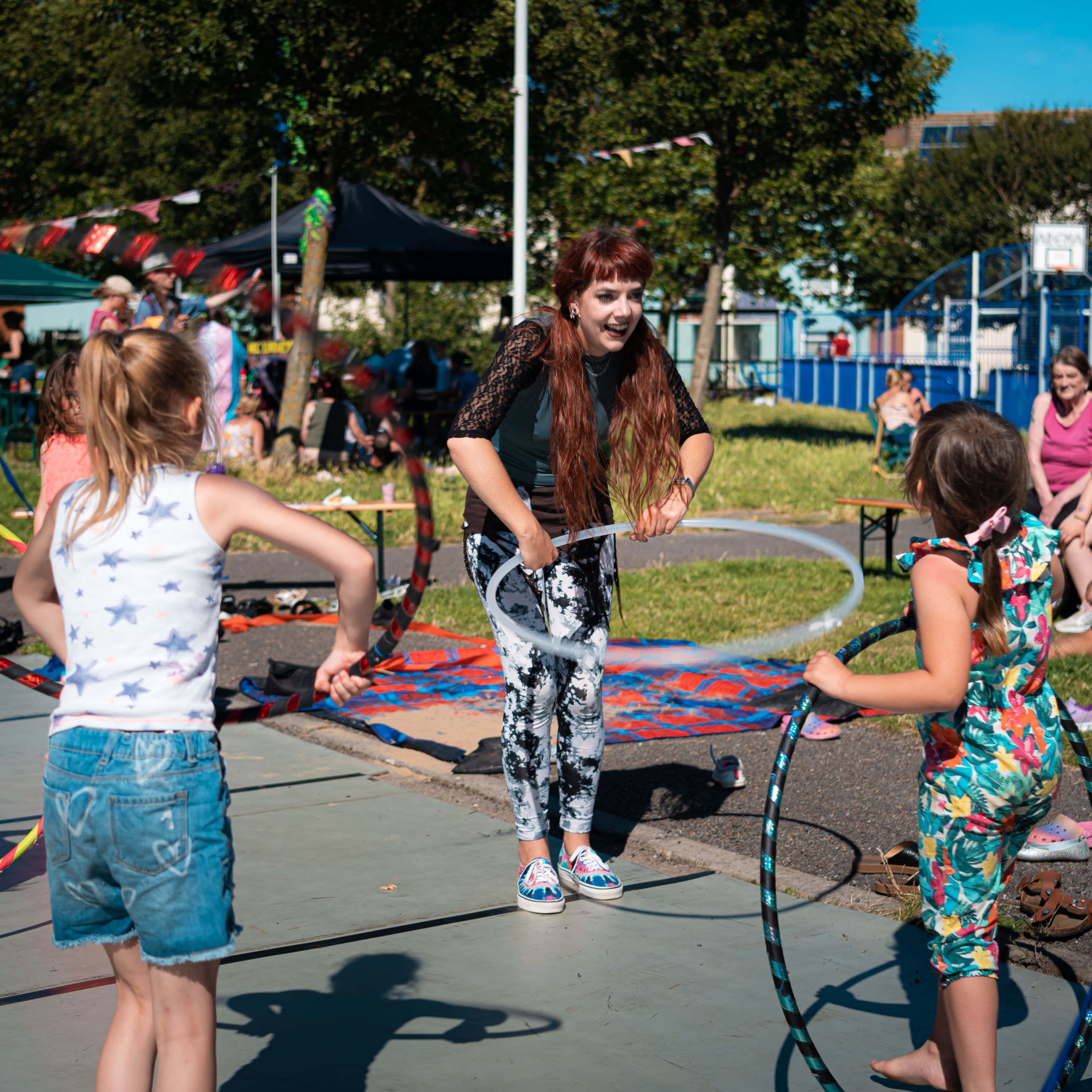 Several people hula hooping or attempting to start it